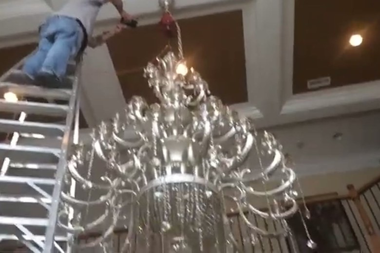 Lowering a chandelier with care